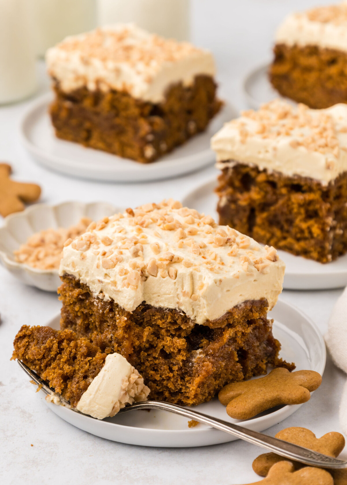 A slice of gingerbread poke cake with a bite of the cake on a fork.