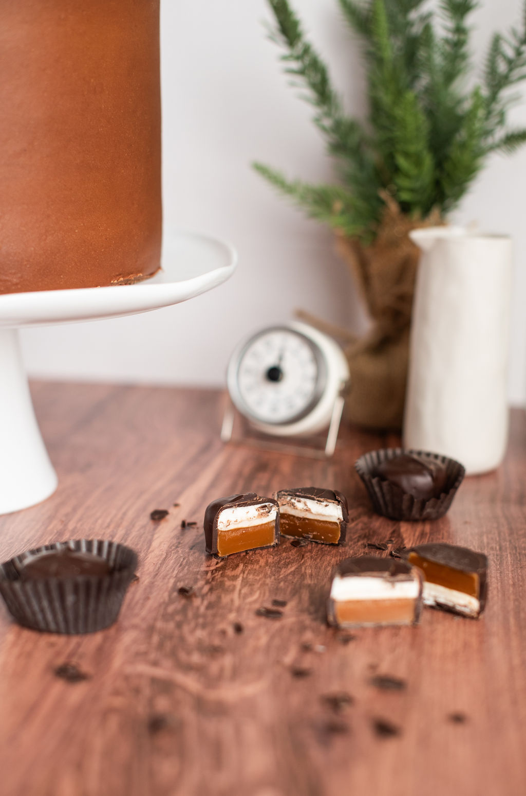 See's candies cut into half pieces next to a cake.