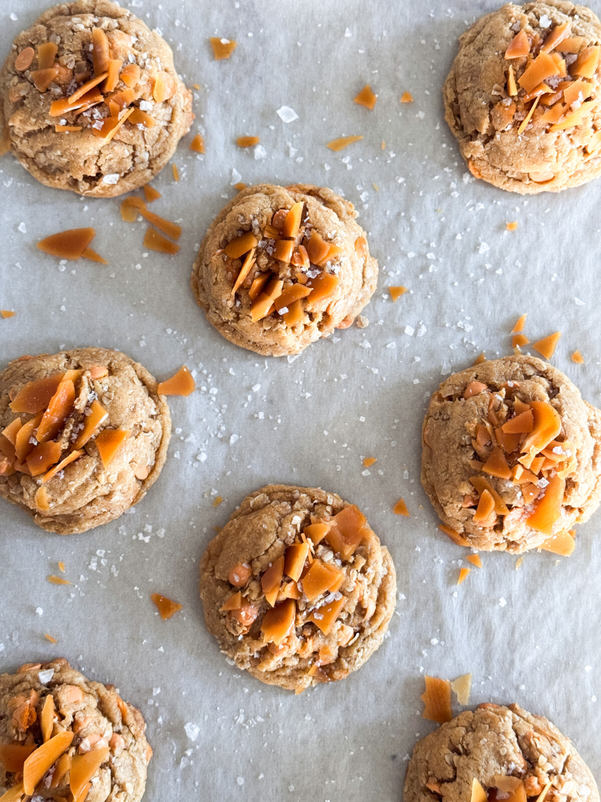 Oatmeal butterscotch salted caramel cookies on a baking sheet.