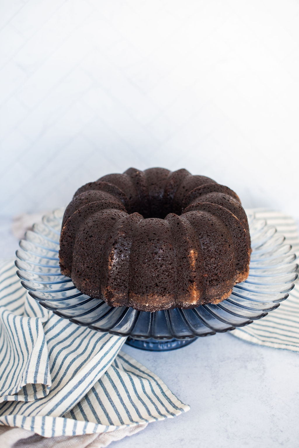 Chocolate banana bundt cake on a cake stand.