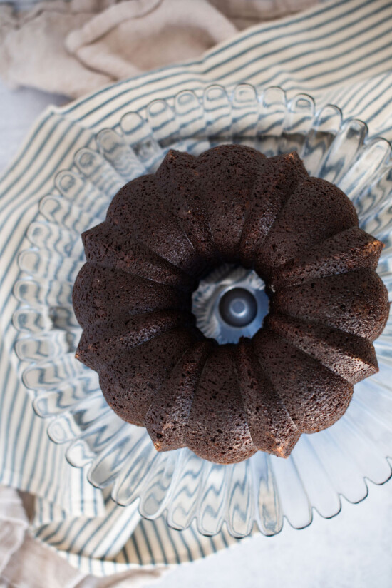 A chocolate banana bundt cake on a cake stand.