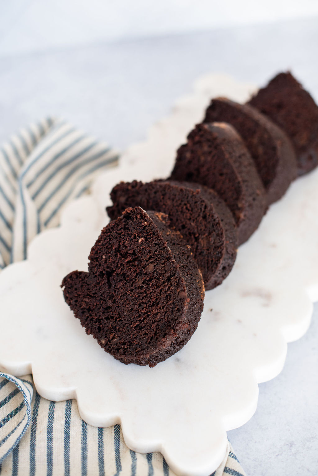 Slices of chocolate banana bundt cake on a tray.