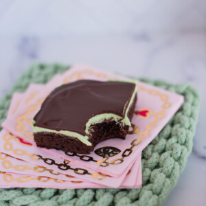 Mint brownie with a bite taken out of it on napkins.