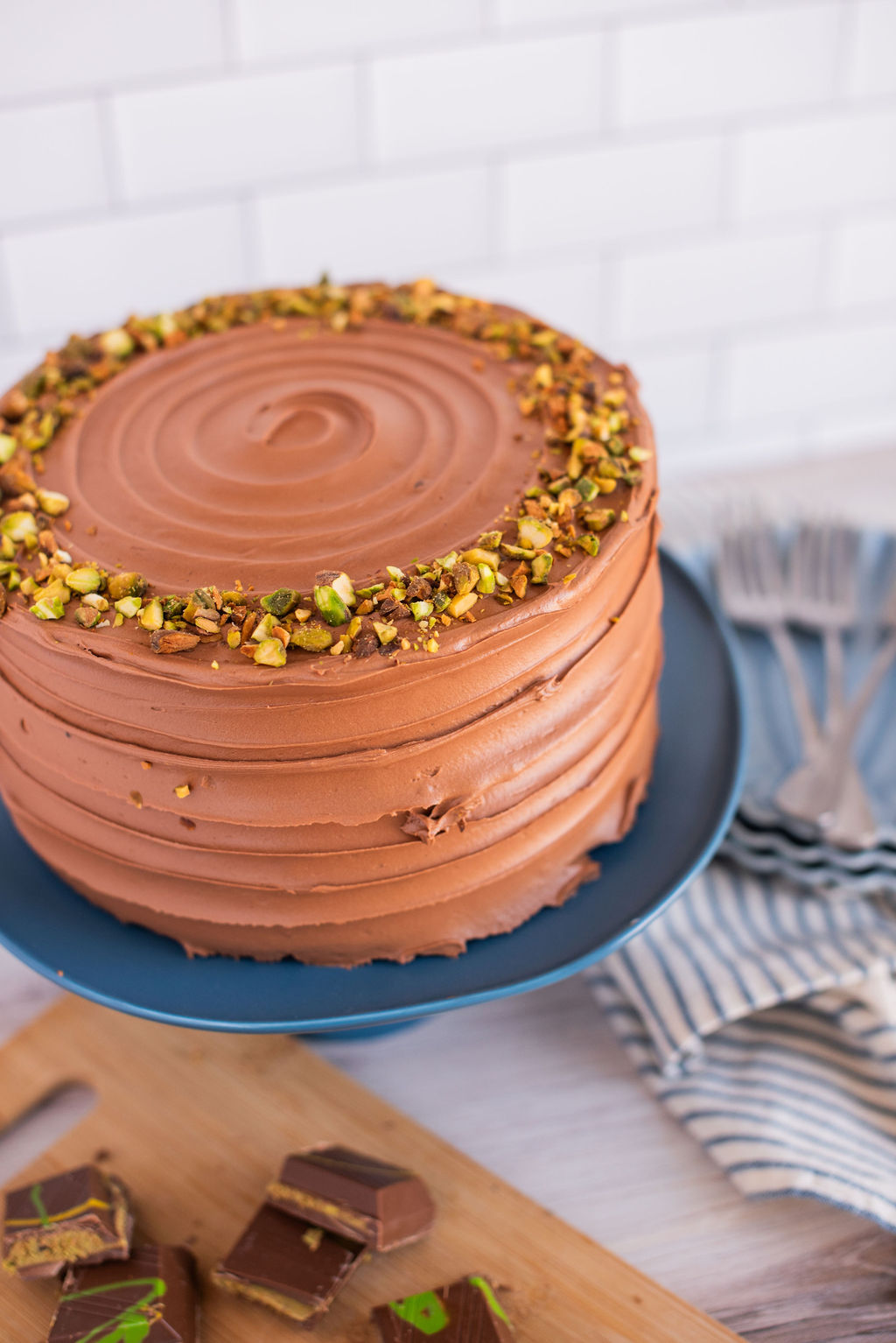 Chocolate cake on a blue cake stand.