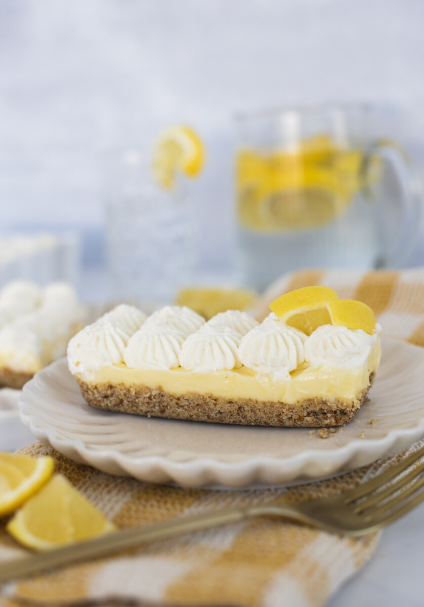 A slice of a lemon tart on a plate.