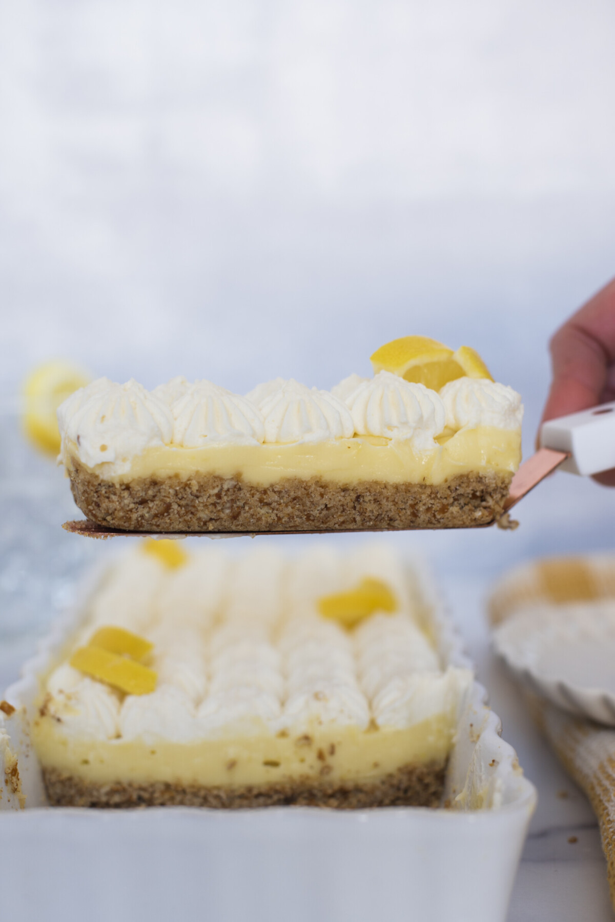A slice of lemon tart on a spatula.
