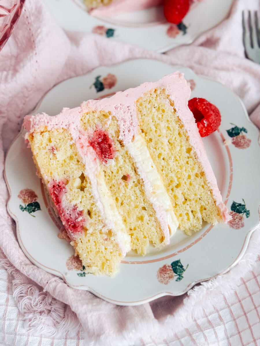 A slice of raspberry cheese danish cake on a floral plate.